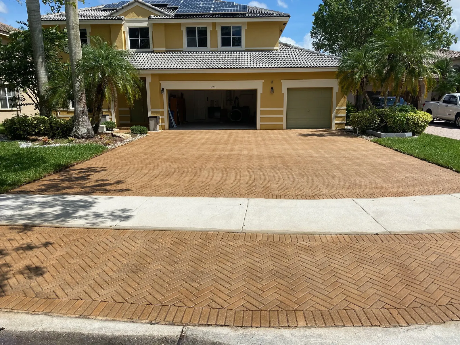 Full paver driveway after SignaSeal enhancement, even color across sun-exposed and shaded areas