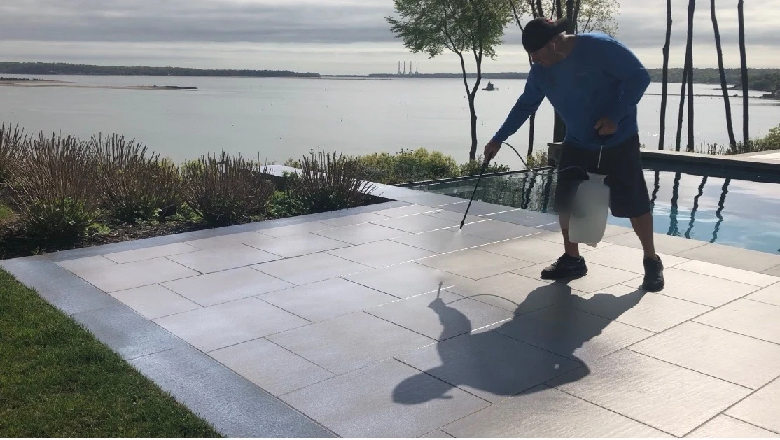 Mark applying the SIGNATRAC treatment on a waterfront dock
